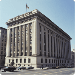Neoclassical civic government building with stone columns and American flag