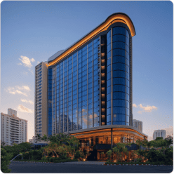Modern high-rise hospitality and residential building with glass facade at dusk